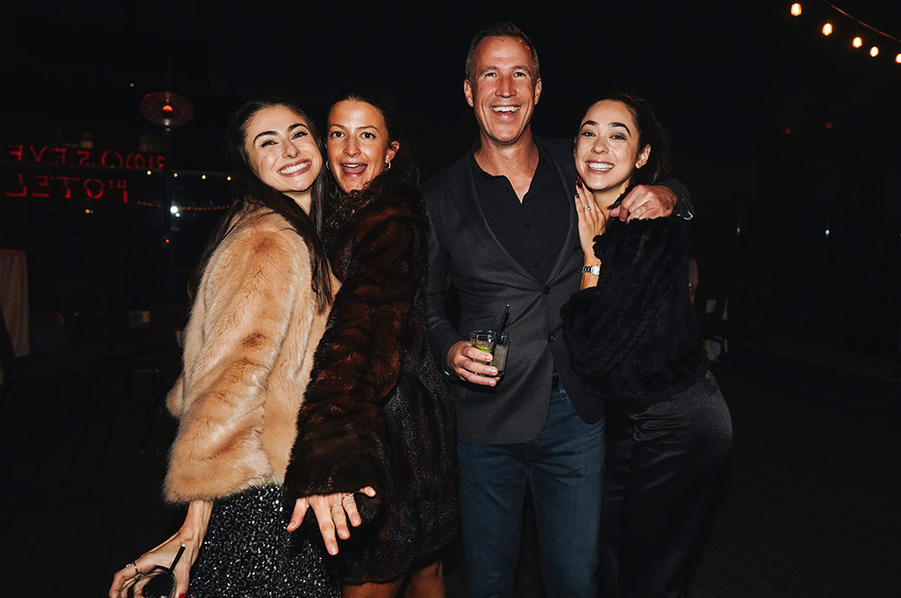 Antonia, Andie, Duncan, and Sara having an amazing time at Miracle Mile's annual holiday party.