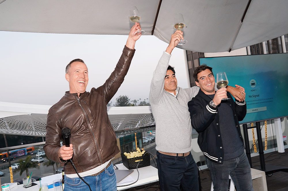 Duncan, Brock, and Matt toasting to the Miracle Mile family at the annual Year End meeting.